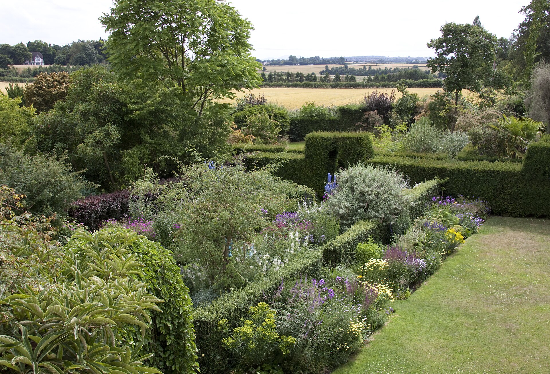 Stone house behind a traditional cottage garden