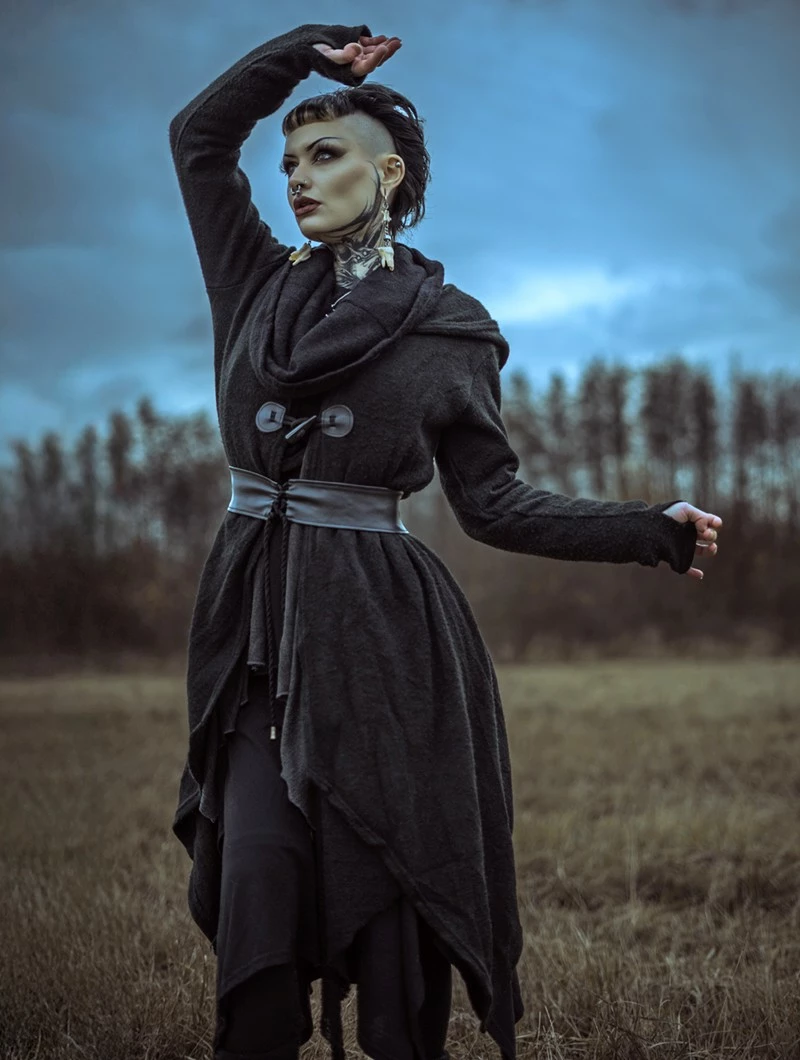 Long black textured cardigan worn outdoors under an overcast sky