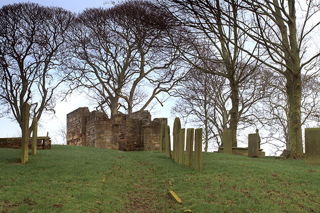 Ruined parish church and graves in a rural Derbyshire churchyard